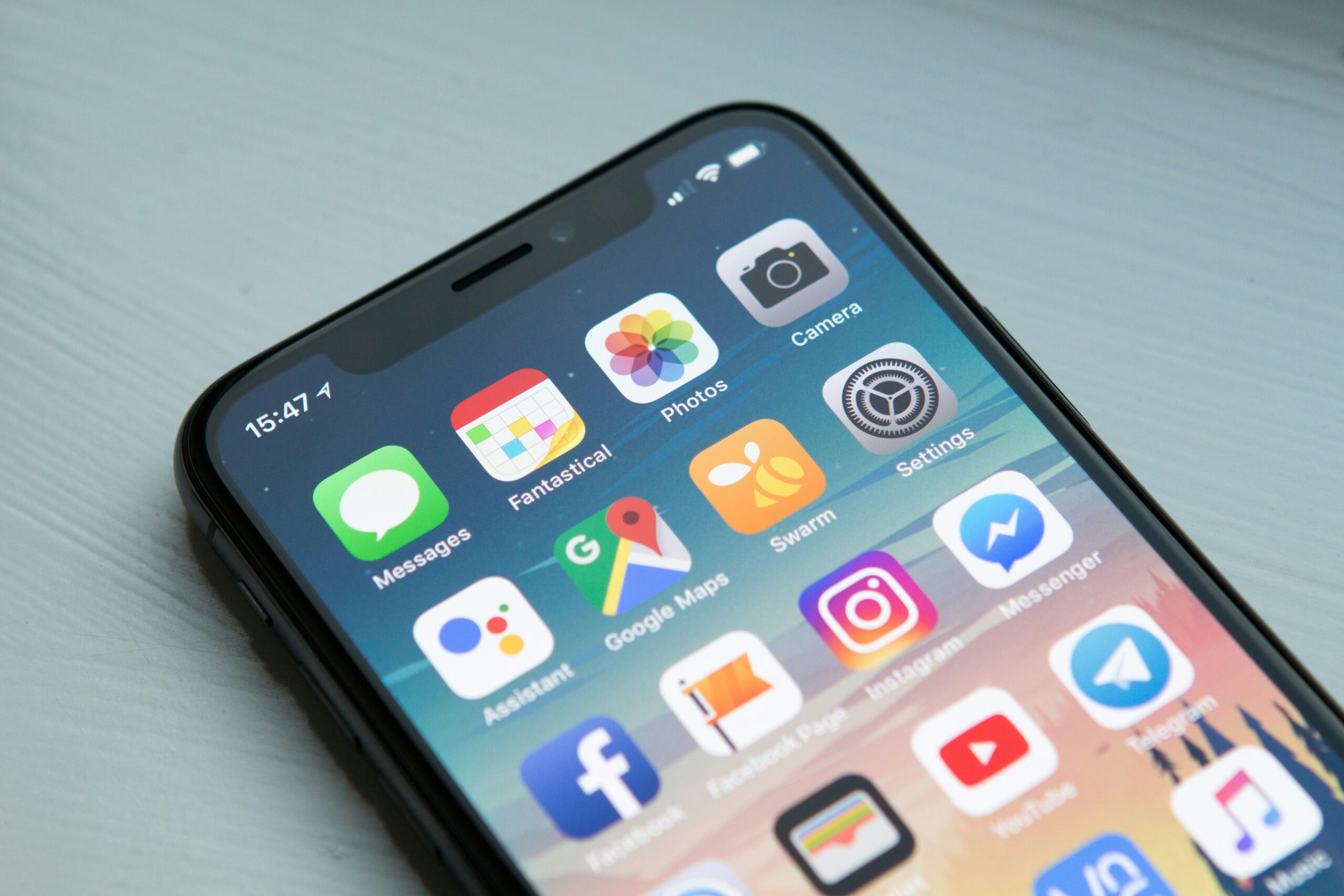 Developer coding mobile app with icons on screen